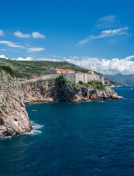 Vertical format of the city walls of the old town in Dubrovnik and coastline