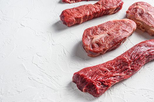 Set of denver, top blade, tri tip steak, machete, flank, bavette London broil marble beef on white background side view close up space for text.