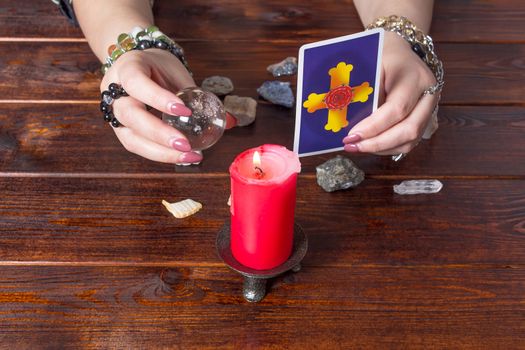 Bangkok, Thailand, March.15.20.A fortune teller holds a magic ball and a Tarot card with a heart.The Gypsy lays out Tarot cards and guesses for the future.Magical sessions with the cards.Clairvoyance