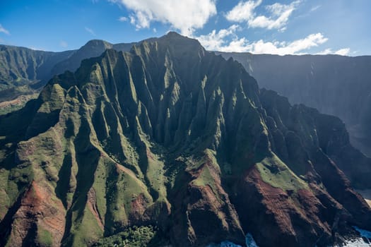 Aerial view of Na Pali coastline and landscape of hawaiian island of Kauai from helicopter flight