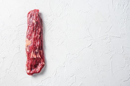 Raw skirt, machete steak on a white stone background space for text