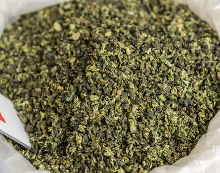 Large bag of green tea leaves drying inside Tulou in Fujian Province in China