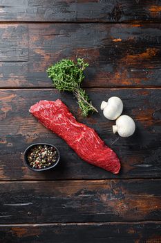 Tri tip steak with fresh seasoningsm thyme, for BBQ on wooden background, top view.