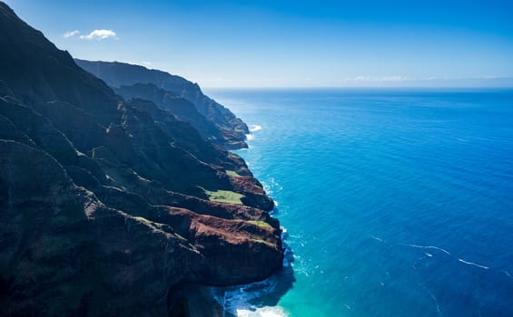 Aerial view of Na Pali coastline and landscape of hawaiian island of Kauai from helicopter flight