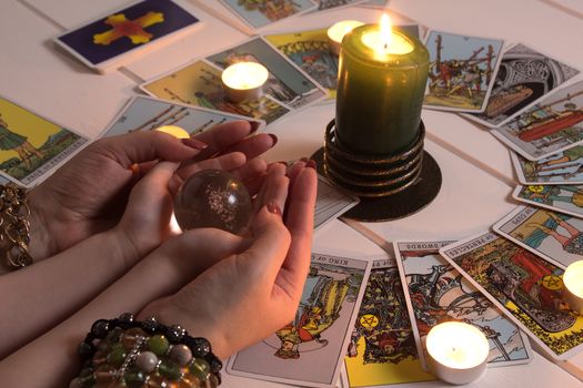 Bangkok,Thailand,March.15.20.Fortune teller predicts fate using a magic ball,stones and a lit candle.A Gypsy telling fortunes by the hand.Christmas fortune telling and fortune telling.Psychic at work