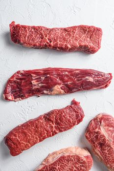 Raw organic machete steak near denver and top blade marble beef on white background top view close up