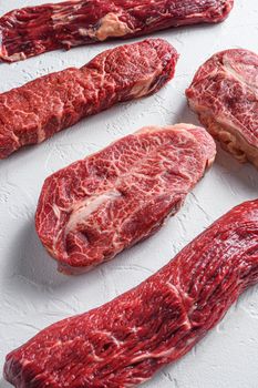 Set of denver, top blade, tri tip steak, machete, flank, bavette London broil marble beef on white background side view close up.