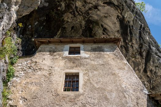Famous castle of Predjama built into a cave in mountain in Slovenia