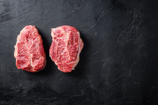 Raw organic meat Top Blade steaks or Australia wagyu oyster blade on black background top view space for text.