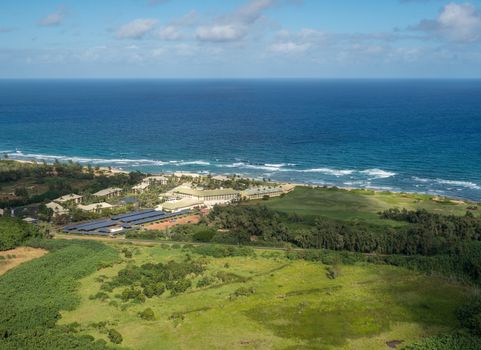 Aerial view of hotel and landscape of hawaiian island of Kauai from helicopter flight