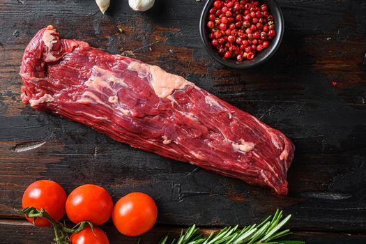 Machete steak raw alternative beef cut or hanging tende cut, with rosemary over wood background Top side view.