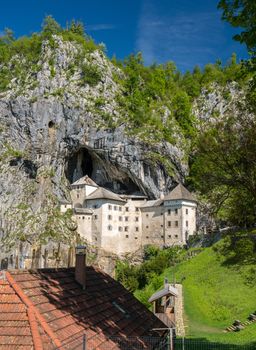 Famous castle of Predjama built into a cave in mountain in Slovenia