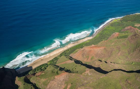 Aerial view of Na Pali coastline and Kalalau beach on hawaiian island of Kauai from helicopter flight