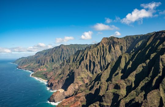 Aerial view of Na Pali coastline and landscape of hawaiian island of Kauai from helicopter flight