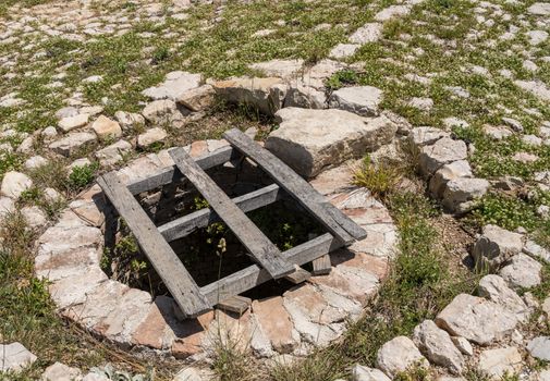 Stone well in the ruins of old Venetian fort above the coastal town of Novigrad in Croatia