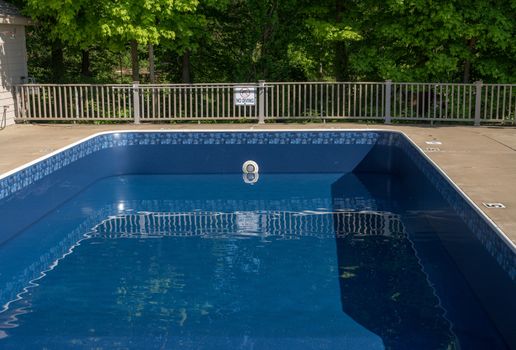 In ground swimming poolwith new vinyl liner being refilled with water ready for use
