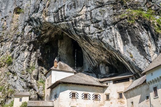 Famous castle of Predjama built into a cave in mountain in Slovenia