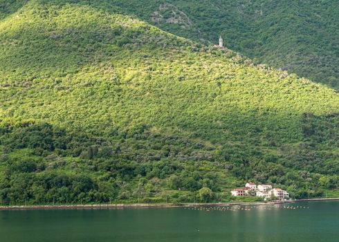 Small church on hillside of coastline of Gulf of Kotor in Montenegro