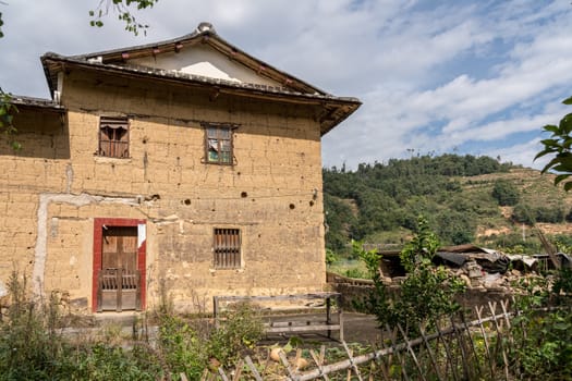 Tea plantations around stone home by Tulou at Unesco heritage site near Xiamen