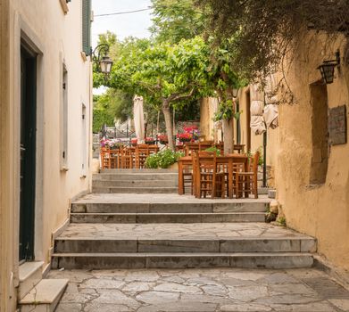 Empty Taverna on steps in ancient neighborhood of Plaka in Athens by the Acropolis