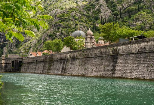 Solid stone walls surround the old town Kotor in Montenegro