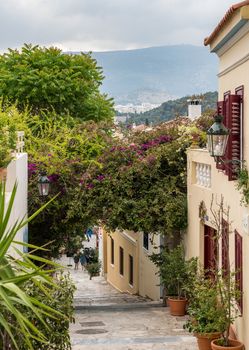 Narrow street with steps in ancient neighborhood of Plaka in Athens by the Acropolis