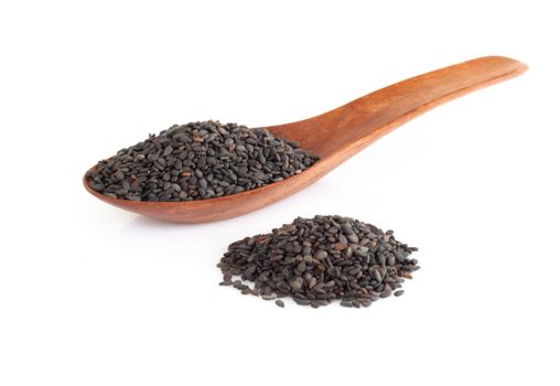 Black sesame seeds in wood spoon isolated on white background