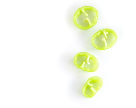 Closeup top view green chilli pepper sliced on white background, raw food ingredient concept