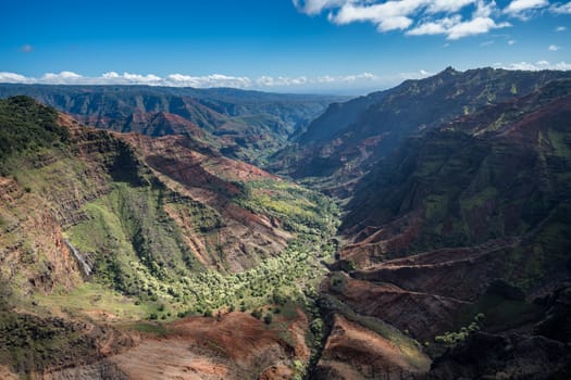 Aerial view of Waimea Canyon and landscape of hawaiian island of Kauai from helicopter flight