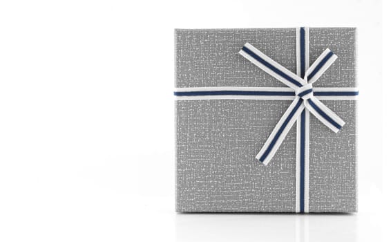 Grey gift box with ribbon on white background, copy space