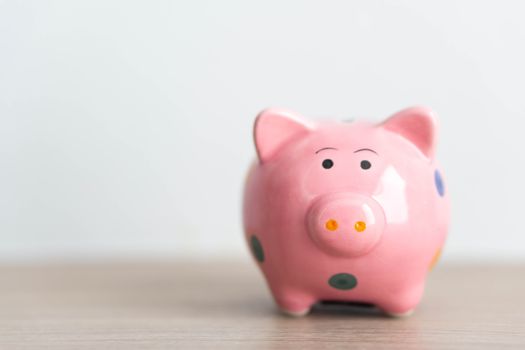 Pink ceramic piggy bank on white background, saving money concept