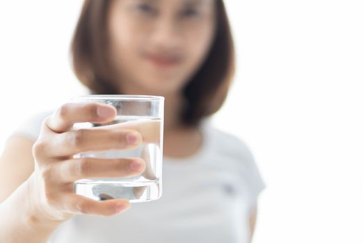 Close up woman holding glass of pure water for drink  with over light, Selective focus