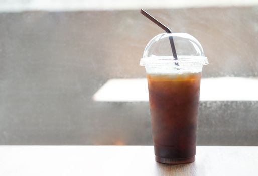 Close up ice of americano on wood table background in coffee shop