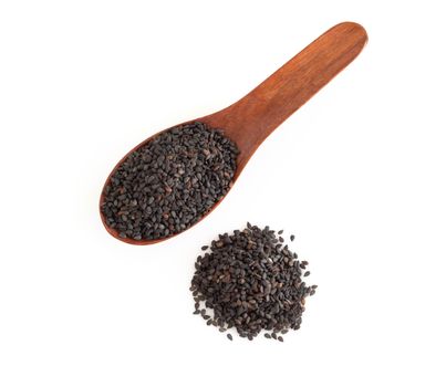 Black sesame seeds in wood spoon isolated on white background