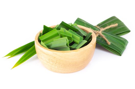 Fresh green pandan leaves with slice in wood bowl isolated on white background