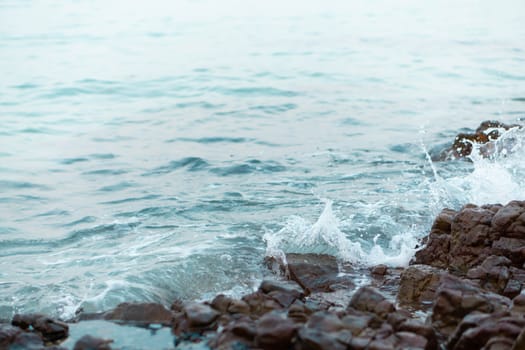 Sea wave breaking with rocky beach, Holiday and relax time concept, selective focus