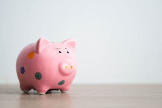 Pink ceramic piggy bank on white background, saving money concept