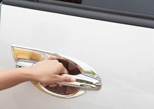 Closeup woman hand on car door handle, selective focus