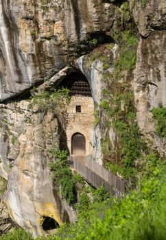 Famous castle of Predjama built into a cave in mountain in Slovenia