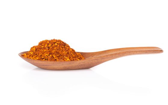 Red chilli power in wood spoon on white background, food ingredient