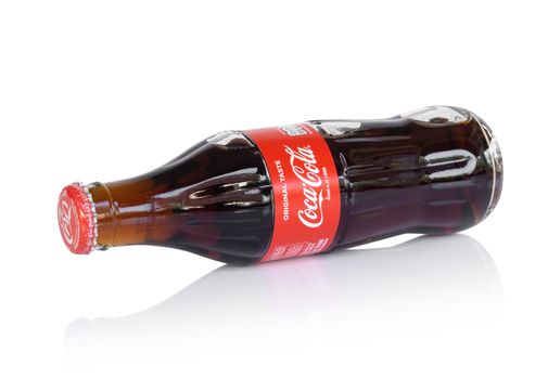 Sakon Nakhon, Thailand - April 21, 2019. Glass bottle of Coca-Cola isolated on white background