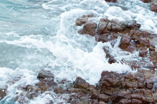 Sea wave breaking with rocky beach, Holiday and relax time concept, selective focus