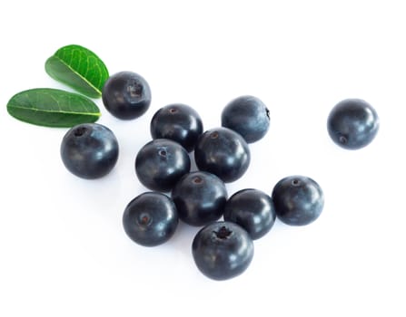 Fresh blueberries with green leaves isolated on white background