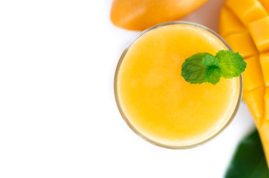 Closeup glass of mango fruit juice isolated on white background