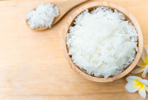 Close up white rice in wooden bowl with spoon, healthy food, selective focus