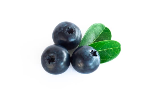 Fresh blueberries with green leaves isolated on white background