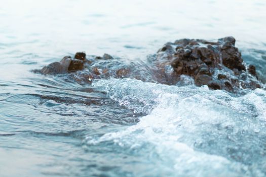 Sea wave breaking with rocky beach, Holiday and relax time concept, selective focus