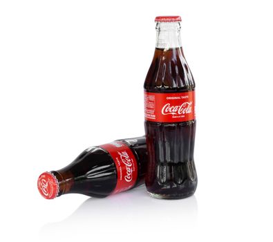 Sakon Nakhon, Thailand - April 21, 2019. Glass bottle of Coca-Cola isolated on white background