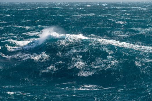 View from cabin balconies at the rough seas and waves off the side of cruise ship