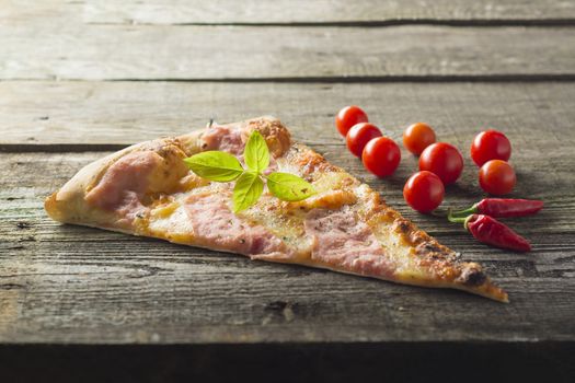 Italian food - pizza on wooden table. Cherry tomato and hot peppers